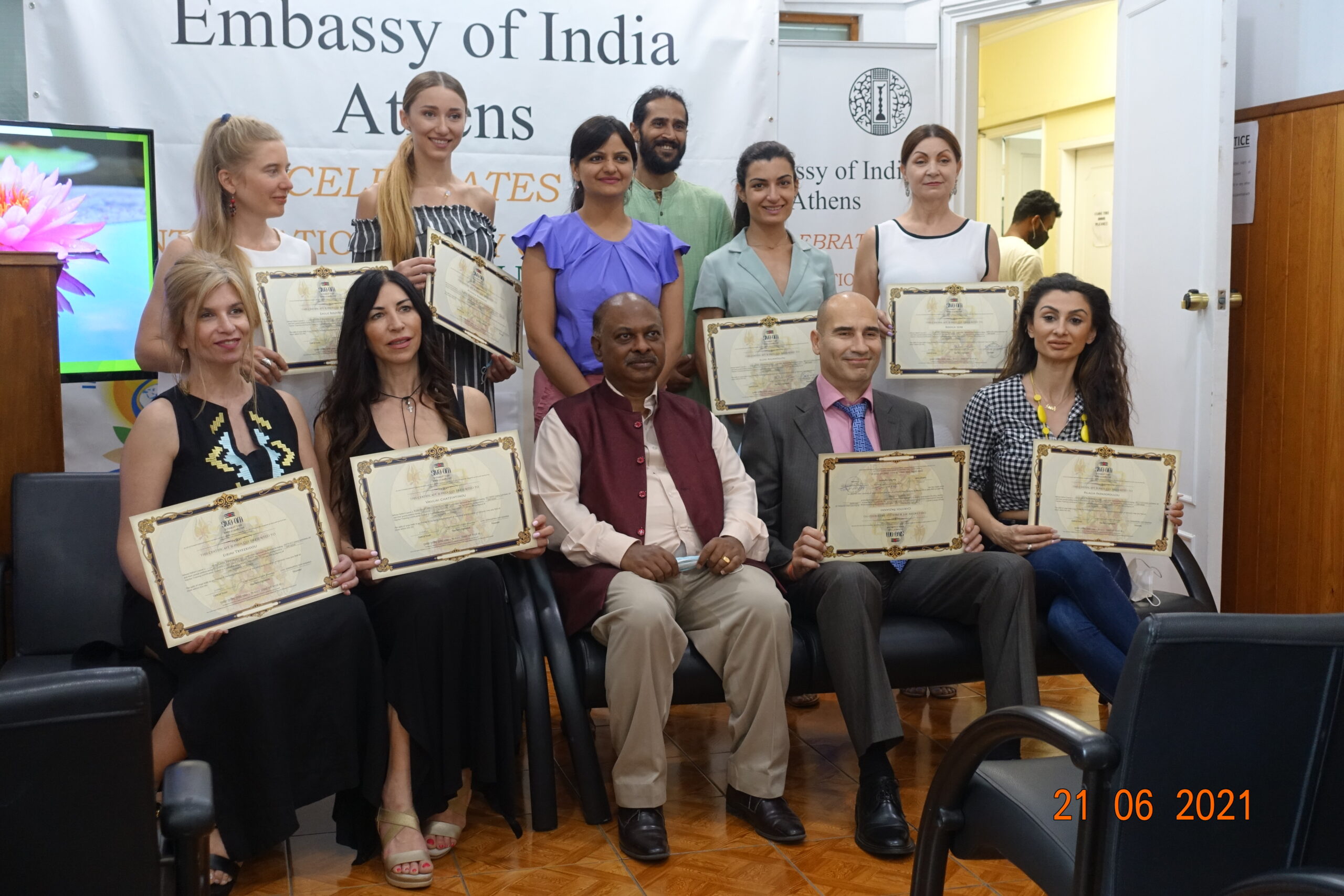 Students receive their siva om yoga instructor education completion certificates from the Ambassador of India to Greece.